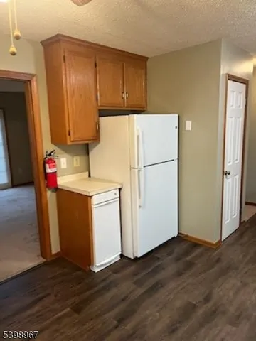 a utility room with wooden floor washer and dryer