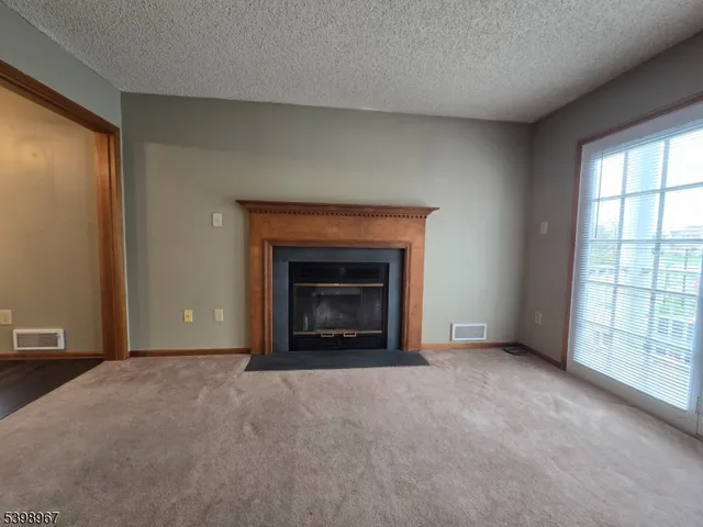 a view of an empty room with a fireplace