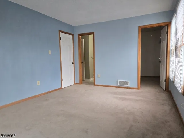 a view of an empty room and a window