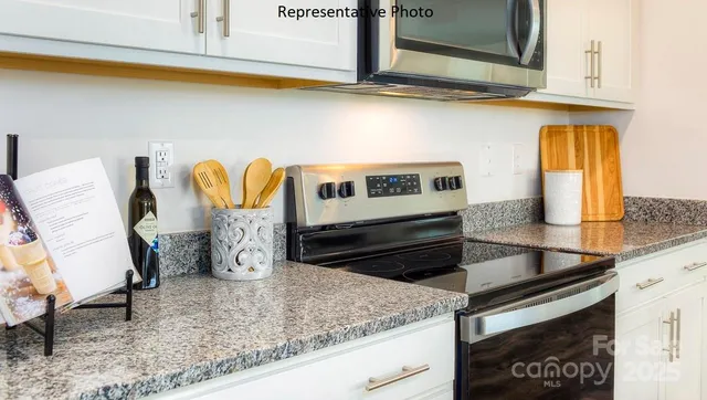 a kitchen with granite countertop a sink and a stove