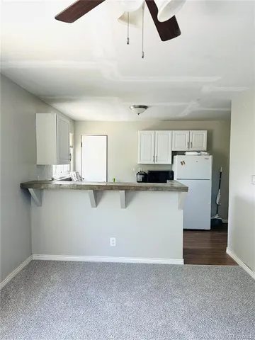 a view of kitchen with white cabinets