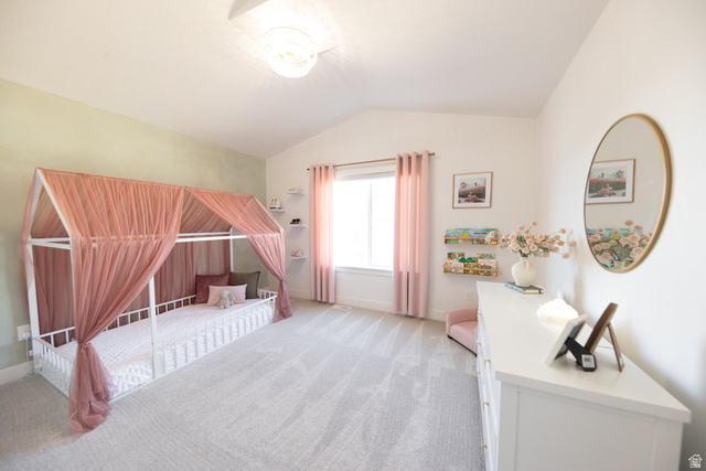 1404 East Rustic Wood Court Sandy, UT 84092 - Photo 21 of 33 Spacious room featuring vaulted ceilings, a large window with privacy coverings, soft carpet flooring, and a contemporary ceiling light fixture