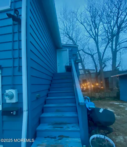 a view of a livingroom with an entryway and wooden floor