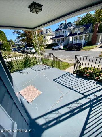 a view of a bedroom with a bed and a window