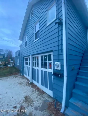 a view of a kitchen with a sink a window and cabinets