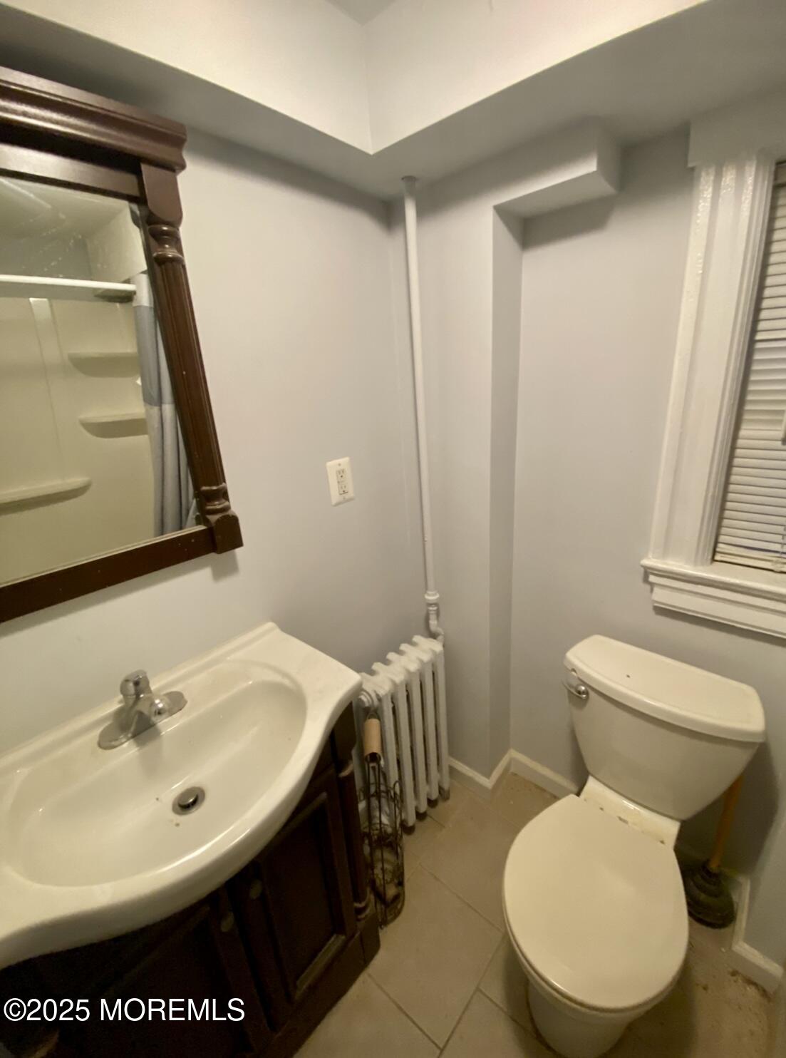 309 Hume Street Allenhurst, NJ 07711 - Photo 49 of 77 a bathroom with a toilet sink and mirror
