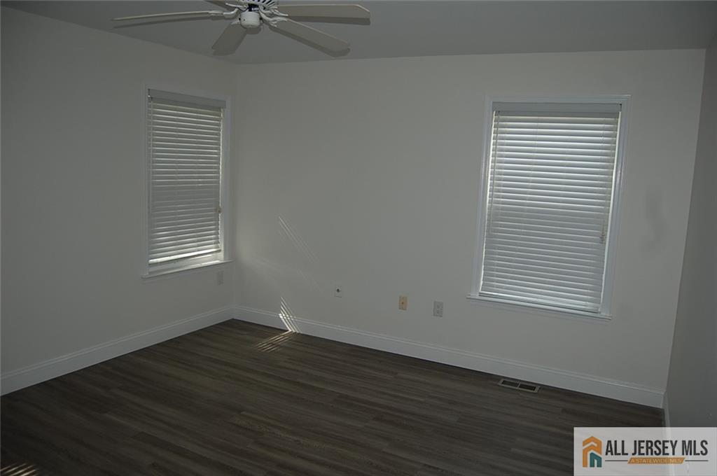 124 Concordia Circle, Unit 124C Monroe Township, NJ 08831 - Photo 12 of 21 an empty room with wooden floor and a window