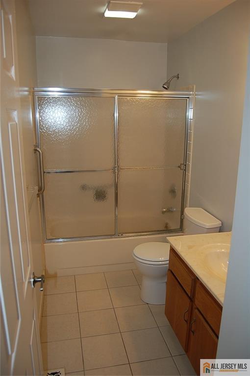 124 Concordia Circle, Unit 124C Monroe Township, NJ 08831 - Photo 15 of 21 a bathroom with a granite countertop shower and a toilet