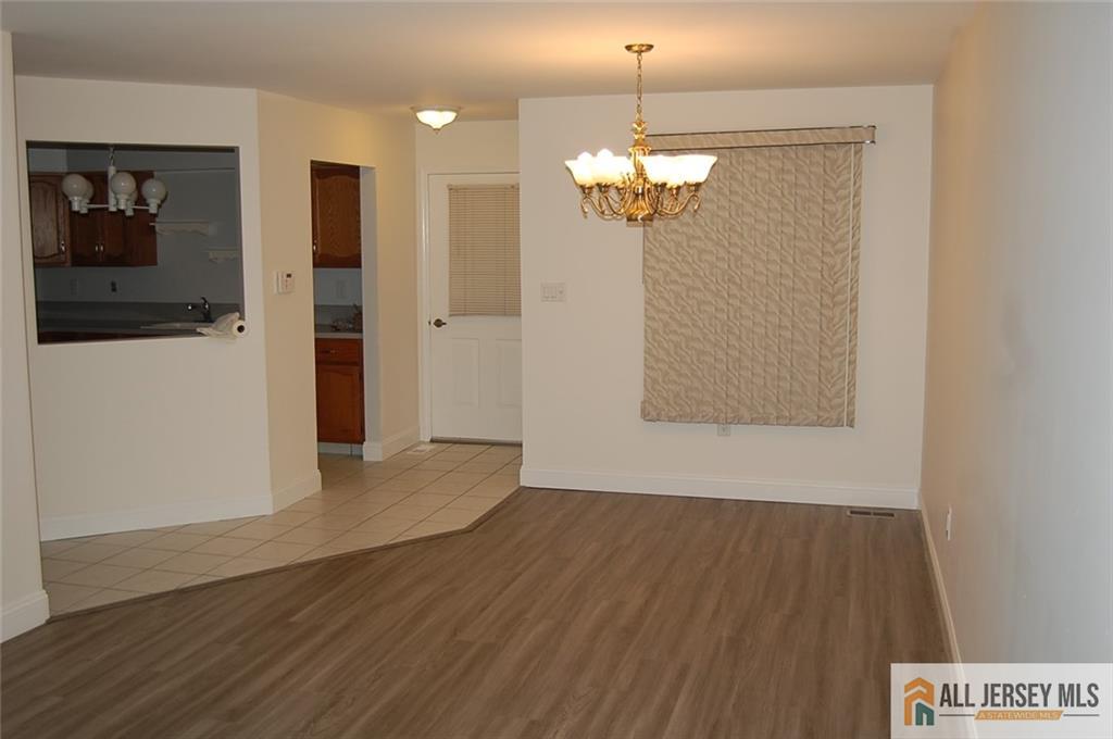 124 Concordia Circle, Unit 124C Monroe Township, NJ 08831 - Photo 6 of 21 wooden floor in an empty room with a window
