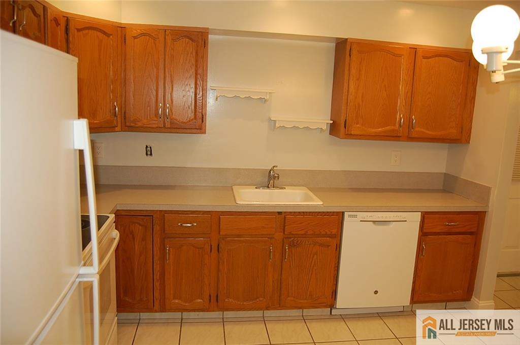 124 Concordia Circle, Unit 124C Monroe Township, NJ 08831 - Photo 7 of 21 a bathroom with a sink and a mirror