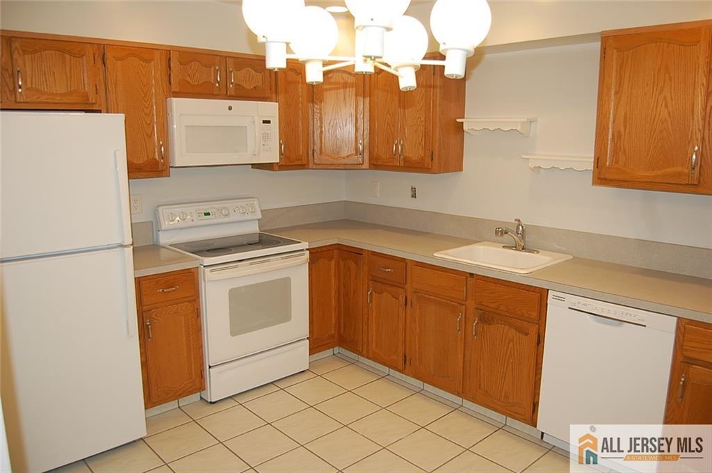 124 Concordia Circle, Unit 124C Monroe Township, NJ 08831 - Photo 8 of 21 a utility room with dryer and washer