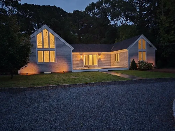 a front view of house with yard and green space