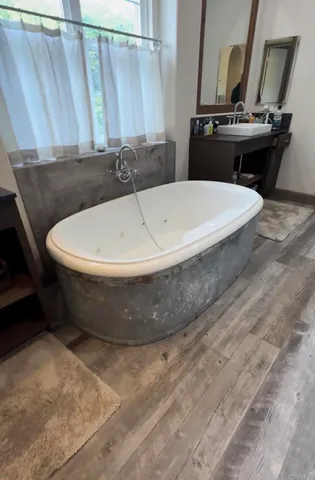 a white bath tub sitting in a bathroom
