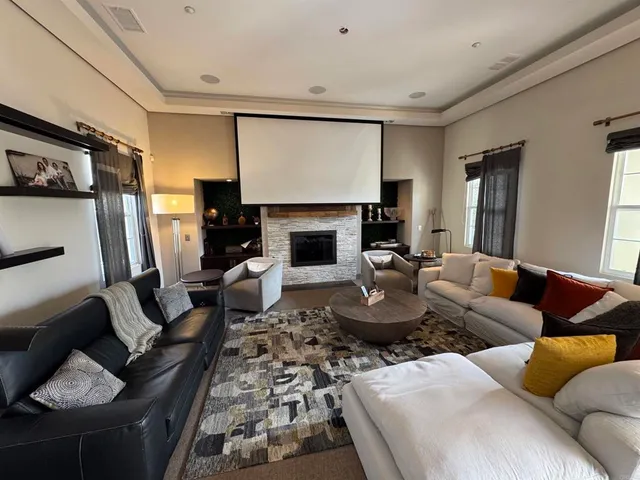 a living room with furniture fireplace and a flat screen tv
