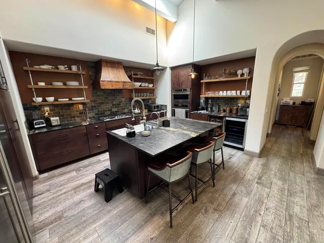 a kitchen with a sink appliances and cabinets