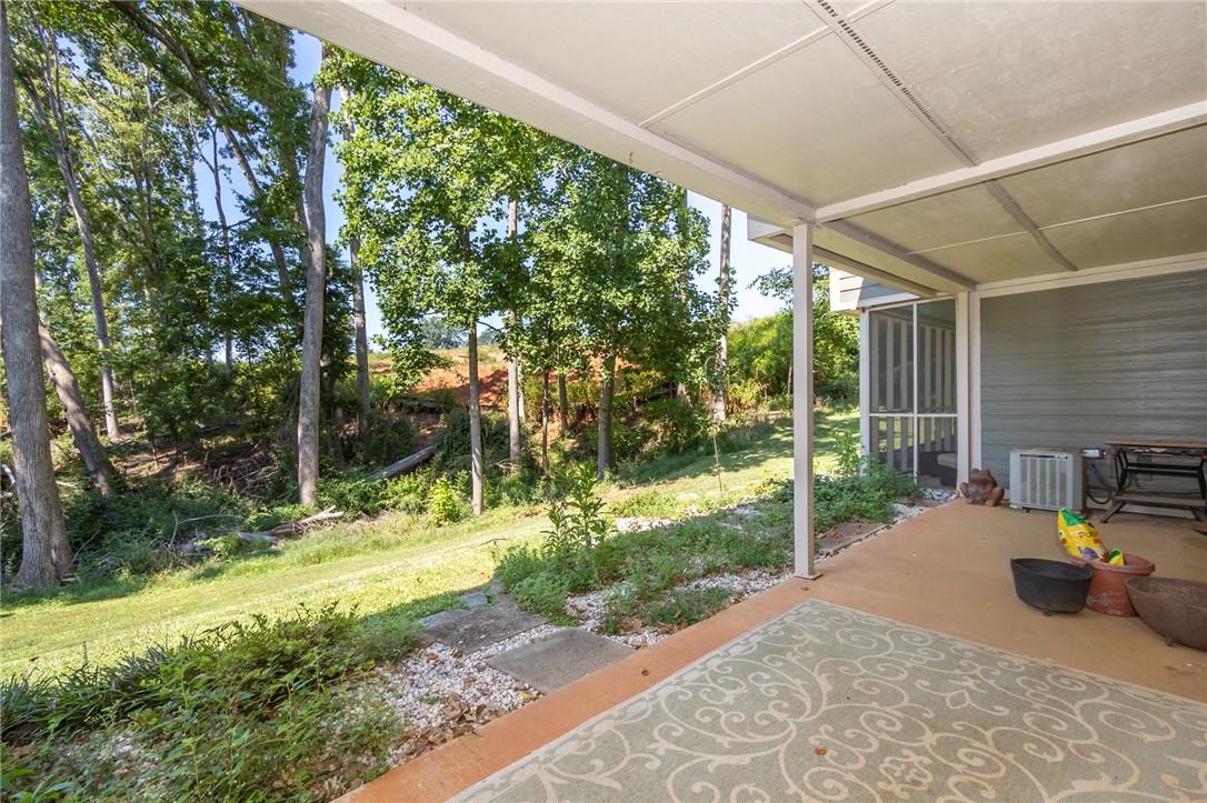 1302 Leeward Road Anderson, SC 29625 - Photo 38 of 50 A covered patio offers a tranquil retreat overlooking a lush, verdant landscape.