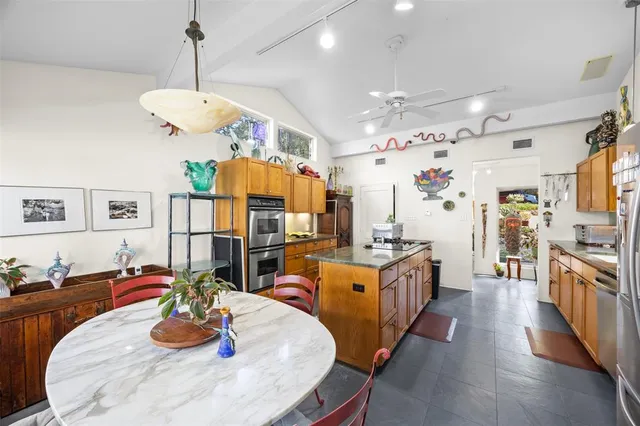 a view of a dining room with furniture and a large window