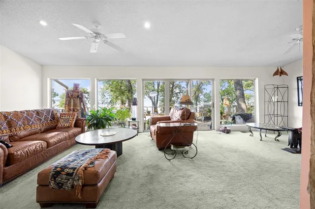 a bedroom with furniture window and a ceiling fan
