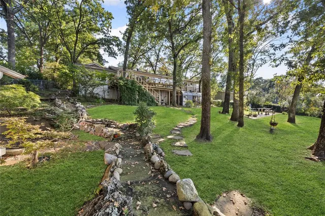 a view of a house with pool deck and outdoor seating