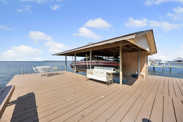 a roof deck with a table and chairs under an umbrella