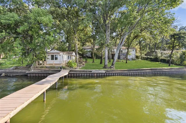 a view of a lake with a floor to ceiling window