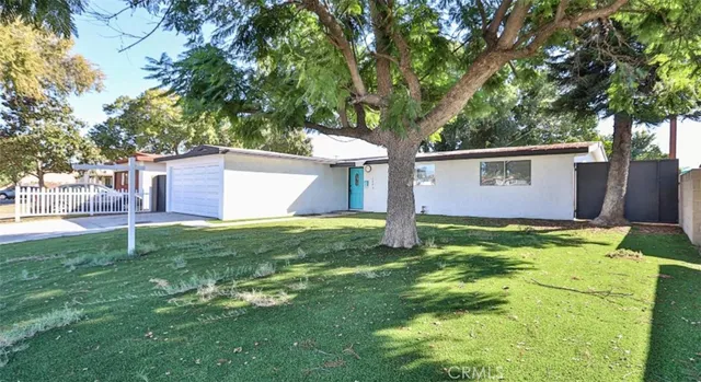 a backyard of a house with table and chairs
