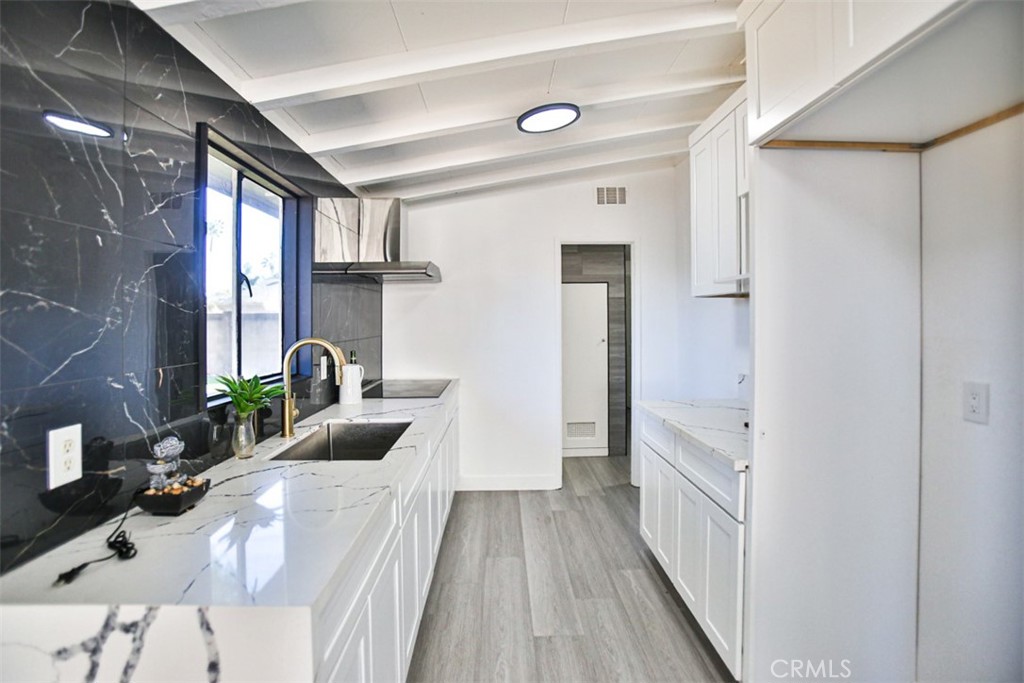 2540 West Picadilly Way Anaheim, CA 92801 - Photo 15 of 37 a bedroom with a bed and a large window with wooden floor