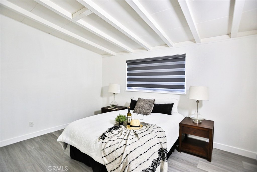 2540 West Picadilly Way Anaheim, CA 92801 - Photo 24 of 37 a bedroom with a bed and wooden floor