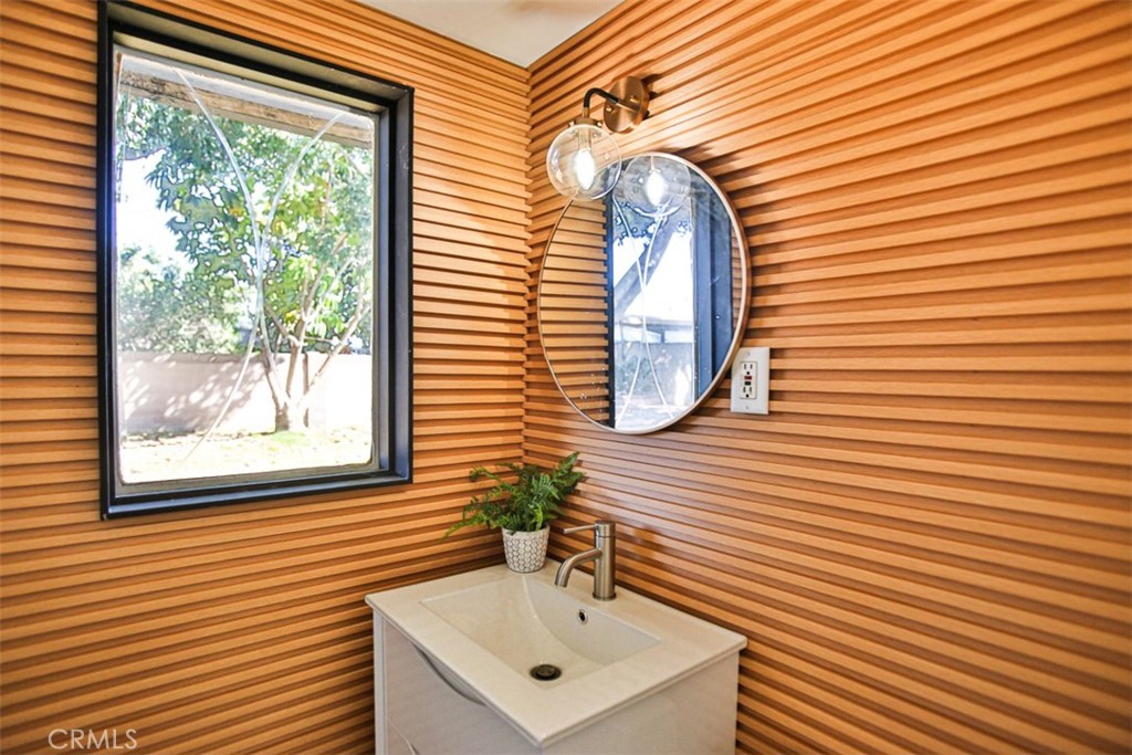 2540 West Picadilly Way Anaheim, CA 92801 - Photo 28 of 37 a bathroom with a sink a mirror and a window