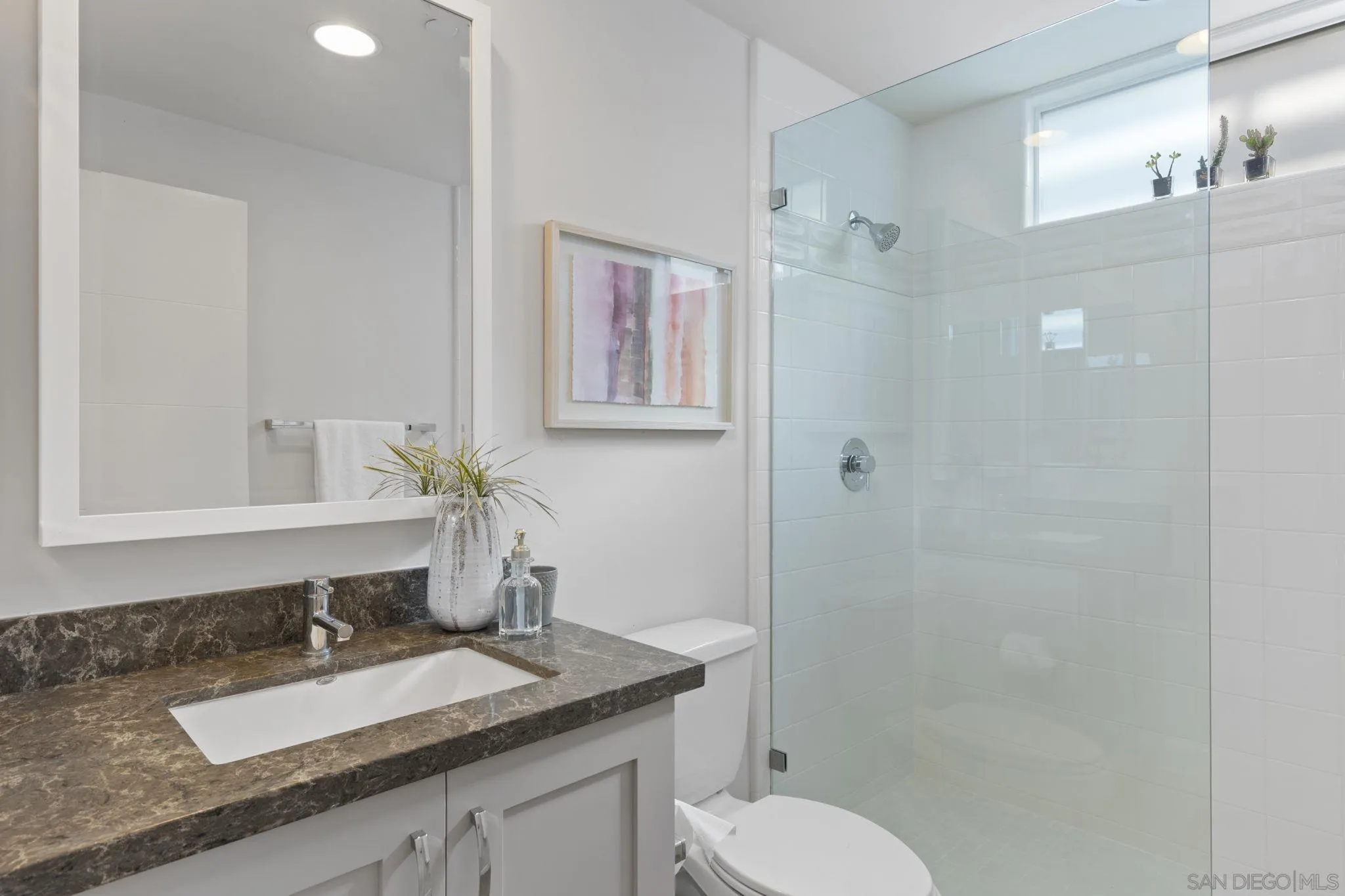 2521 State Street Carlsbad, CA 92008 - Photo 18 of 30 a bathroom with a granite countertop sink toilet and shower
