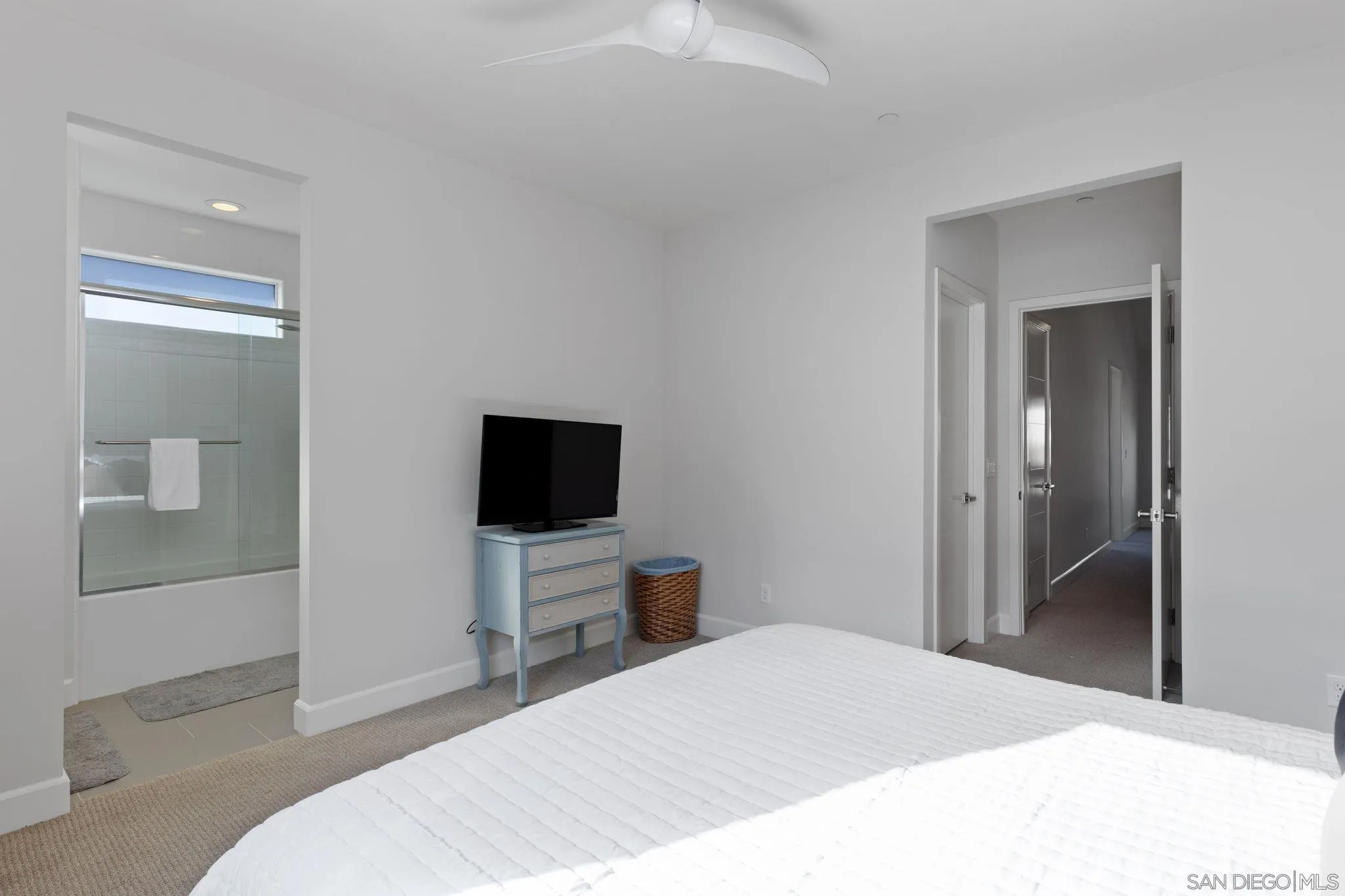 2521 State Street Carlsbad, CA 92008 - Photo 20 of 30 a bedroom with a bed and a flat tv screen on wall