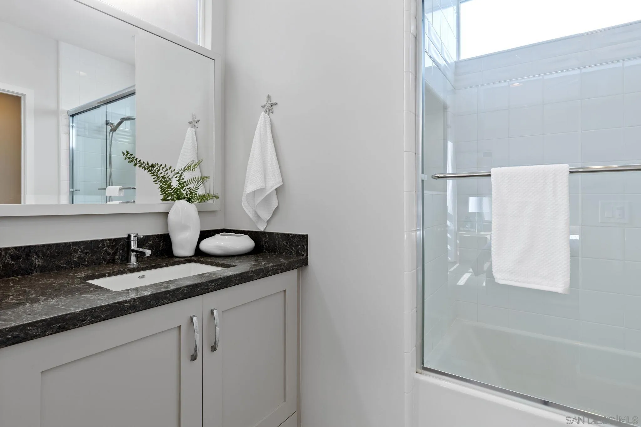2521 State Street Carlsbad, CA 92008 - Photo 21 of 30 a bathroom with a granite countertop sink and a mirror