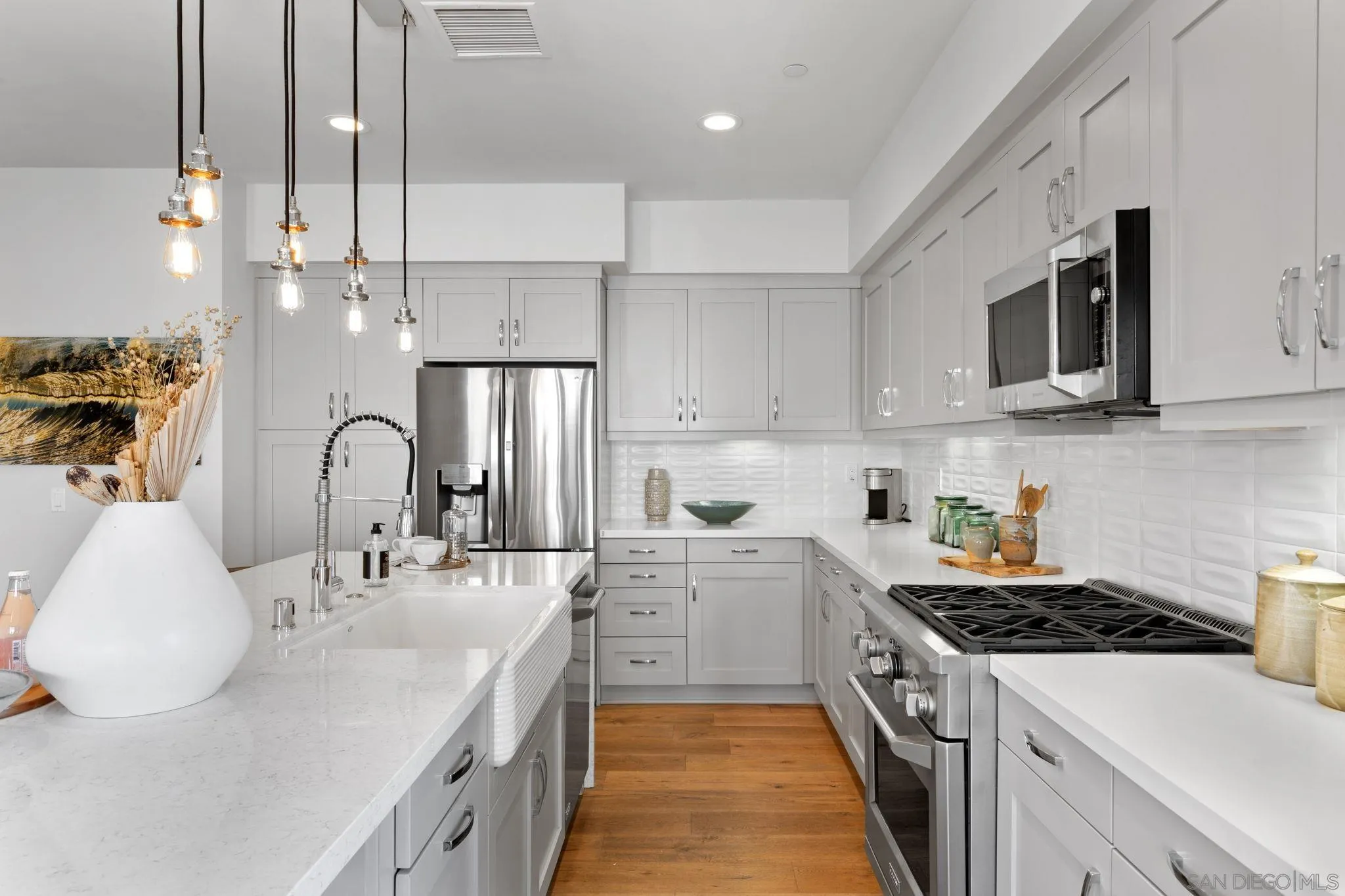 2521 State Street Carlsbad, CA 92008 - Photo 7 of 30 a kitchen with stainless steel appliances granite countertop a sink a stove and a refrigerator