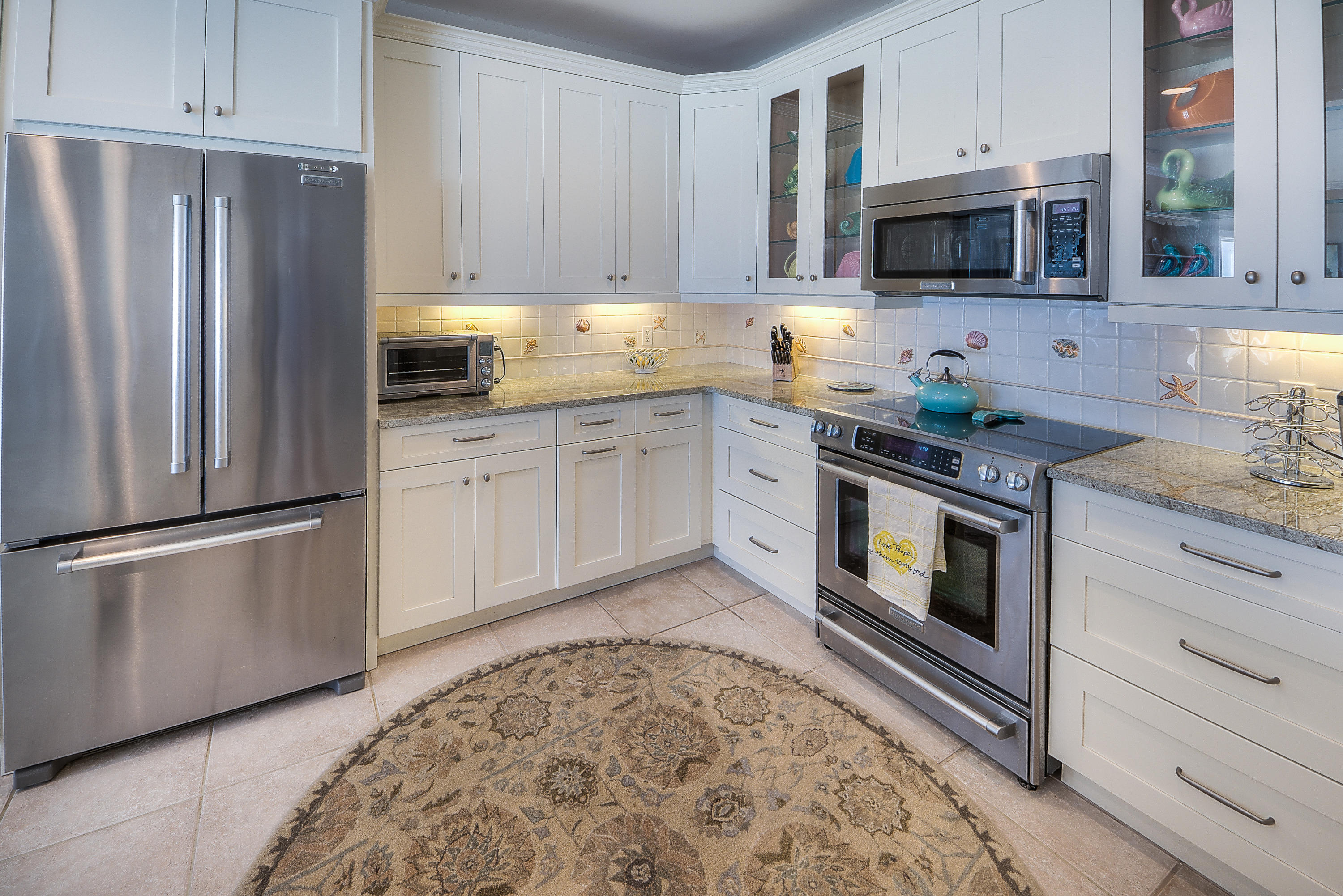 43 Fort Panic Road Santa Rosa Beach, FL 32459 - Photo 20 of 44 a kitchen with stainless steel appliances granite countertop a stove a refrigerator and a microwave