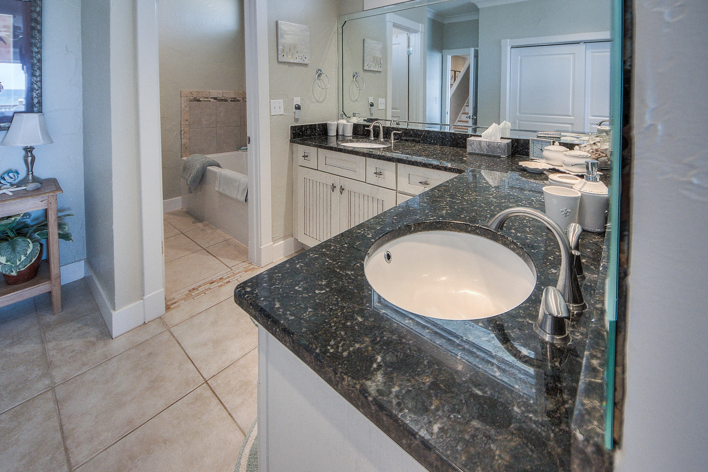 43 Fort Panic Road Santa Rosa Beach, FL 32459 - Photo 23 of 44 a bathroom with a granite countertop sink a mirror and bathtub