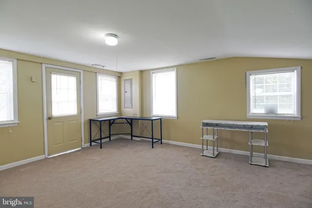 a view of a bedroom with furniture and a window