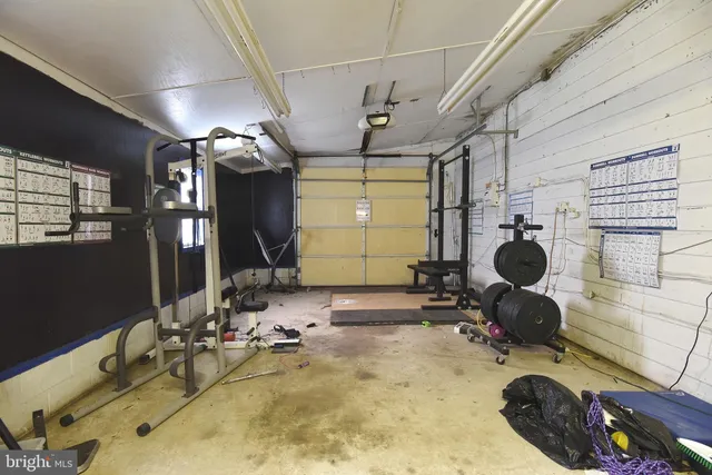 a room with gym equipment and windows