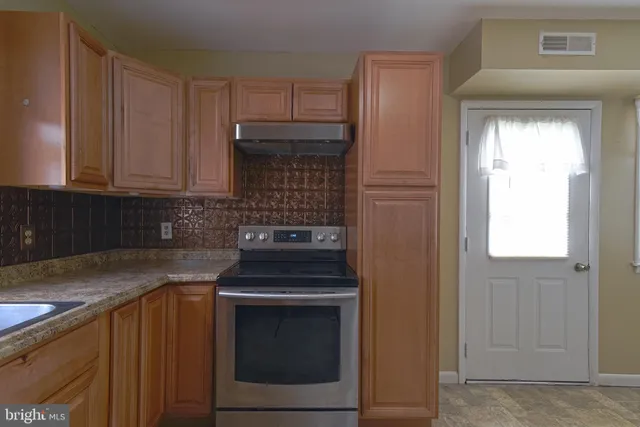 a kitchen with a stove and a sink