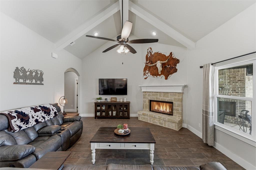 3020 Westfork Way Springtown, TX 76082 - Photo 13 of 40 a living room with furniture a fireplace and a flat screen tv