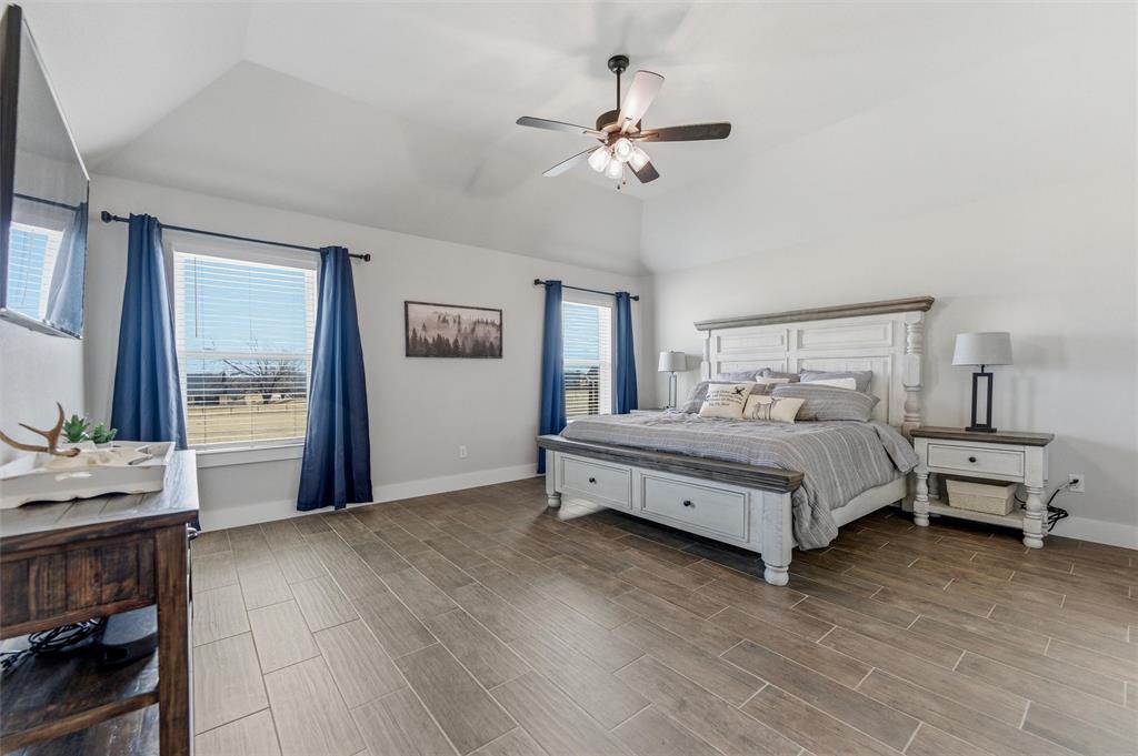 3020 Westfork Way Springtown, TX 76082 - Photo 19 of 40 a bedroom with a bed and large windows
