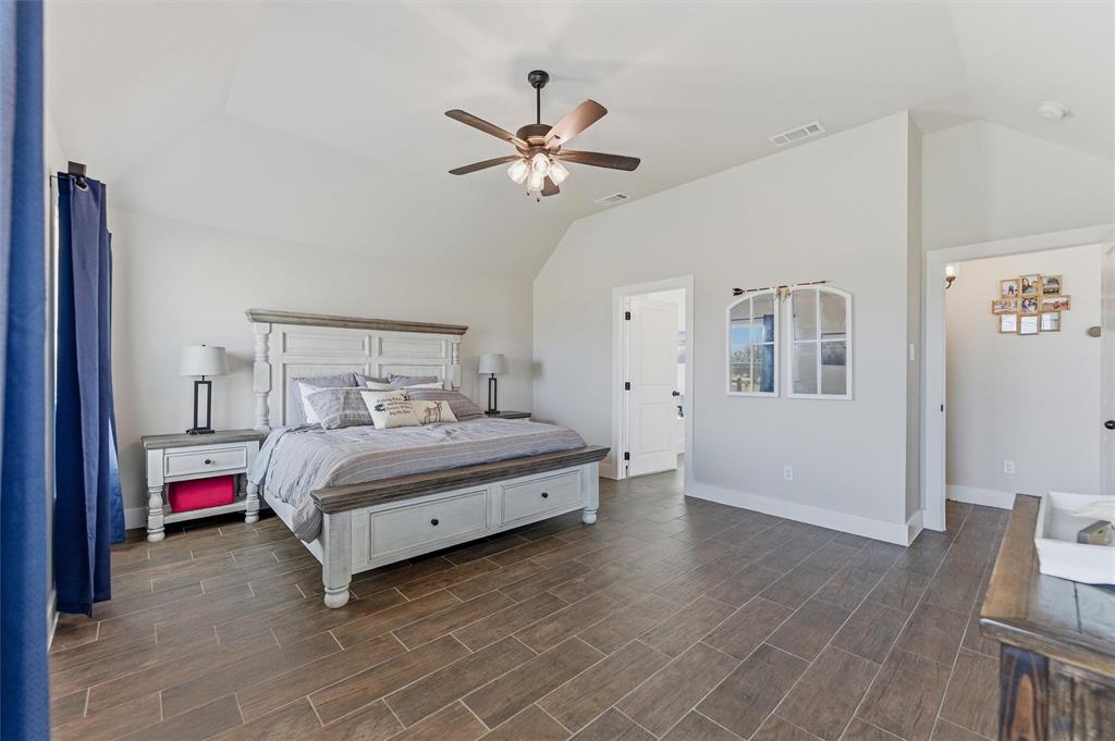 3020 Westfork Way Springtown, TX 76082 - Photo 20 of 40 a bedroom with a bed and a chandelier