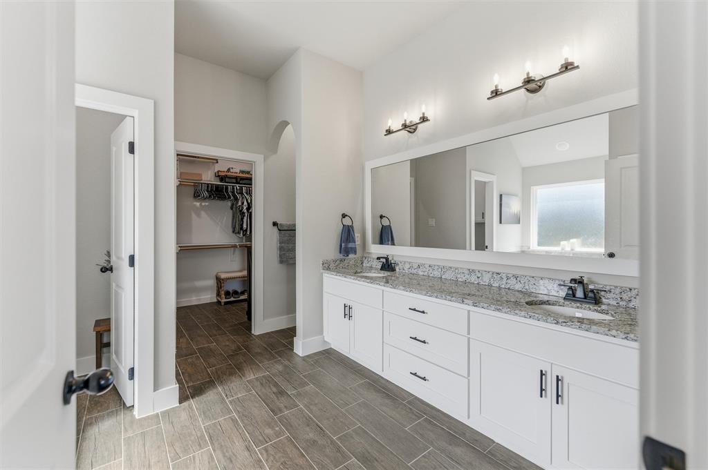3020 Westfork Way Springtown, TX 76082 - Photo 22 of 40 a spacious bathroom with a granite countertop sink mirror and a shower