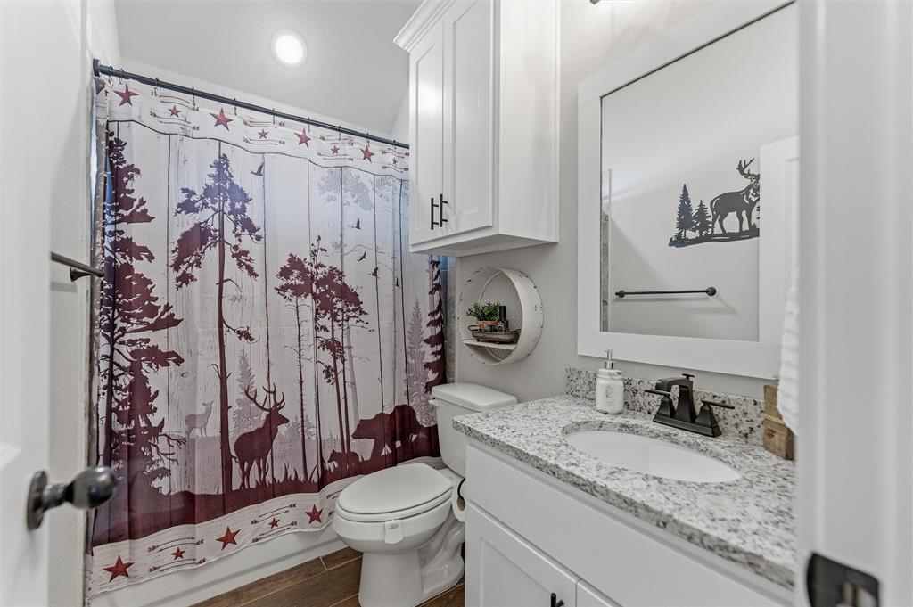3020 Westfork Way Springtown, TX 76082 - Photo 27 of 40 a bathroom with a granite countertop sink toilet and shower