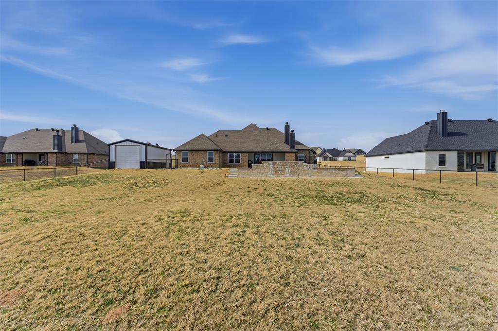3020 Westfork Way Springtown, TX 76082 - Photo 32 of 40 a large pool with lawn chairs under an umbrella