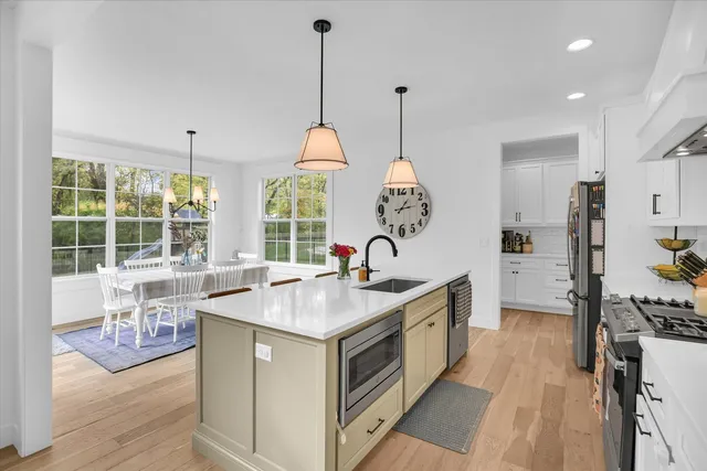 a kitchen with a stove and a wooden floor