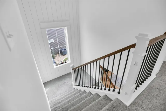 a bedroom with a bed and a chandelier fan