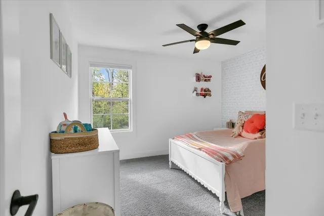 a spacious bedroom with a bed and a chandelier