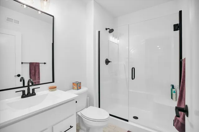 a bedroom with a bed and ceiling fan