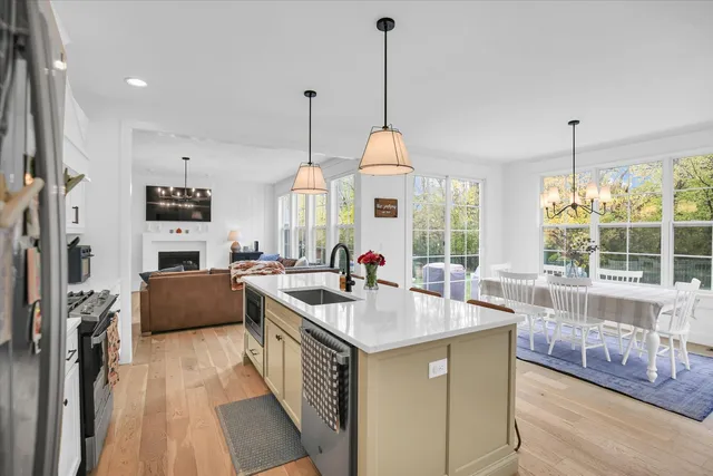 a view of a dining room with furniture large windows and wooden floor
