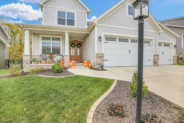 a view of a white house with a big yard and large trees